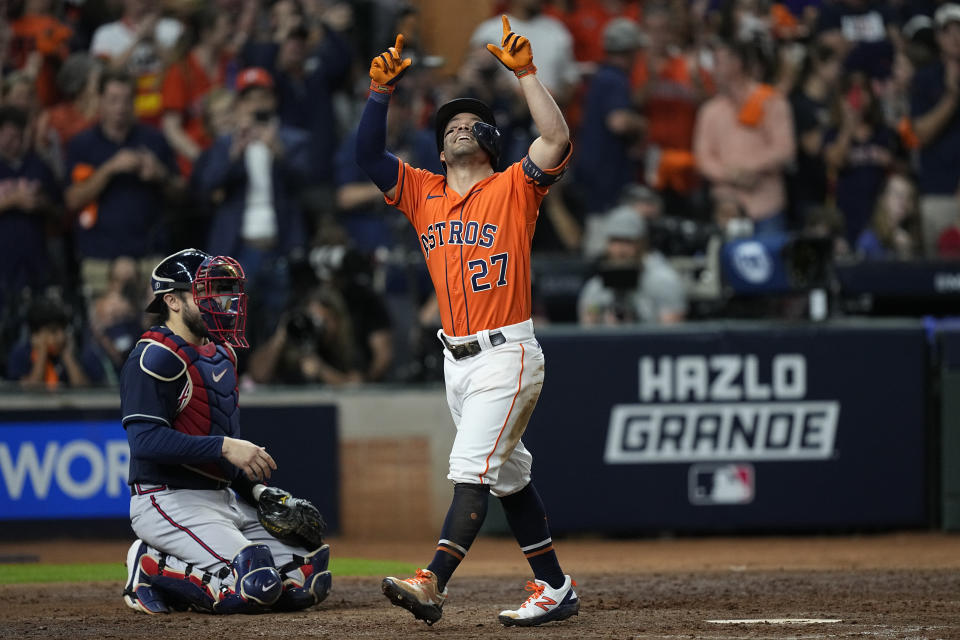 Houston Astros' Jose Altuve celebrates after a home run during the seventh inning in Game 2 of baseball's World Series between the Houston Astros and the Atlanta Braves Wednesday, Oct. 27, 2021, in Houston. (AP Photo/David J. Phillip)