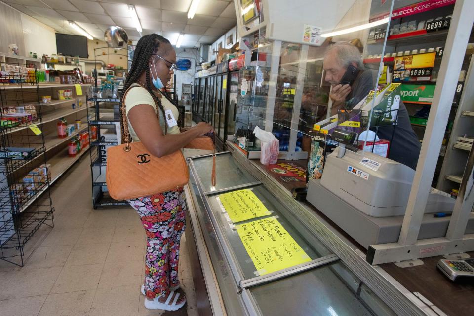 Beyanca Cannon visits the Yellow Store for a soft drink one last time Friday. The longtime Pensacola convenience store is closing its doors after 32 years.