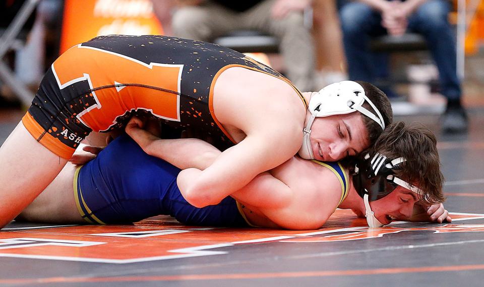 Ashland's Jon Metzger wrestles Wooster's Grant Hoffman during their 157 lbs match at the Ohio Cardinal Conference wrestling championships at Ashland High School Saturday, Feb. 18, 2023. TOM E. PUSKAR/ASHLAND TIMES-GAZETTE