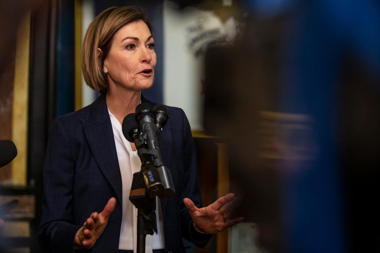 Gov. Kim Reynolds speaks to the press after signing House File 2416 into law, prohibiting transgender women and girls from competing in female sports offered by Iowa schools, colleges and universities, on Thursday, March 3, 2022, in the rotunda of the Iowa State Capitol, in Des Moines. 