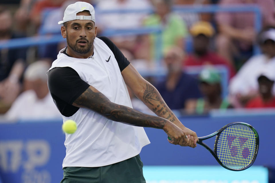 Nick Kyrgios, of Australia, hits a backhand to Marcos Giron, of the United States, at the Citi Open tennis tournament in Washington, Tuesday, Aug. 2, 2022. (AP Photo/Carolyn Kaster)