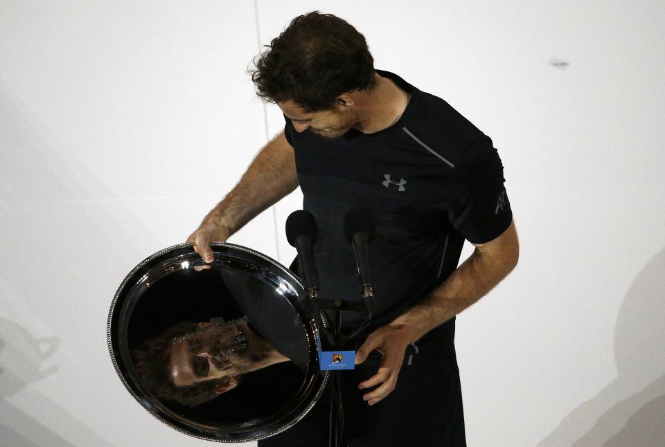 Britain's Andy Murray is reflected in the runner-up plate as he looks at it after losing his final match against Serbia's Novak Djokovic at the Australian Open tennis tournament at Melbourne Park, Australia, January 31, 2016. REUTERS/Jason Reed