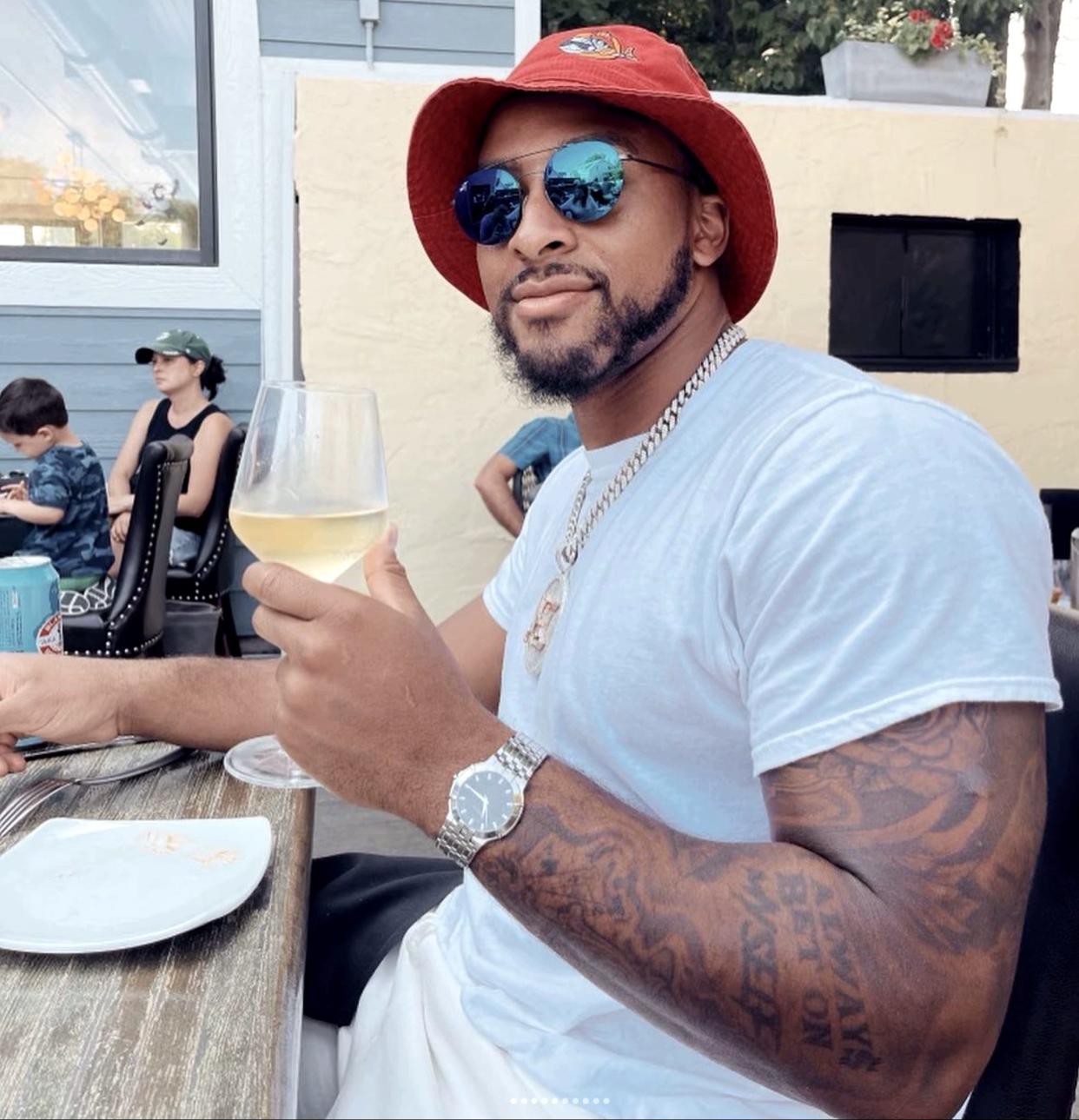 Green Bay Packers running back AJ Dillon relaxes with a glass of wine at Clover & Zot in Baileys Harbor. Dillon is known around these parts as "the mayor of Door County."