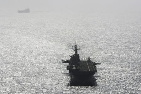 USS Boxer (LHD-4) ship sails near a tanker in the Arabian Sea off Oman