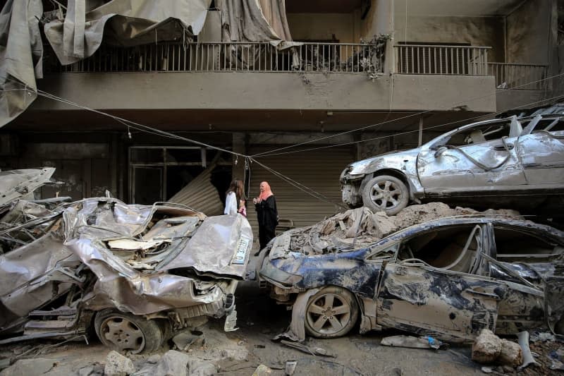 Residents of destroyed apartments arrive to check on their flats at the site targeted by Israeli airstrikes in central Beirut. At least 22 people were killed and 117 others injured, the Lebanese Health Ministry said, in what appeared to be the deadliest attack in the Lebanese capital in more than a year of fighting between Israel and Hezbollah. Marwan Naamani/dpa