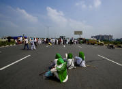 Protesting farmers gather at Singhu, outskirts of New Delhi, India, Monday, Sept.27, 2021. Thousands of Indian farmers Monday blocked traffic on major roads and railway tracks outside of the nation's capital, calling on the government to rescind agricultural laws that they say will shatter their livelihoods. The farmers called for a nation-wide strike to mark one year since the legislation was passed, marking a return to protests that began over a year ago. (AP Photo/Manish Swarup)