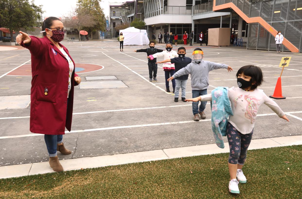 Lilia Guerrero, left, with students