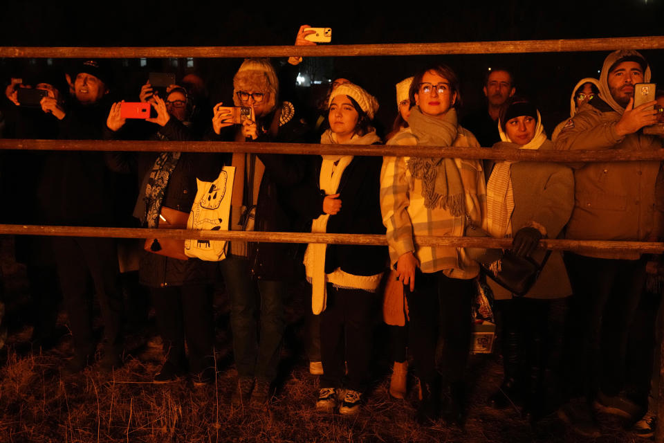 Iranian Zoroastrians look at and take pictures of a giant bonfire as they celebrate their ancient mid-winter Sadeh festival in the outskirts of Tehran, Iran, Tuesday, Jan. 30, 2024. Hundreds of Zoroastrian minorities gathered after sunset to mark their ancient feast, creation of fire, dating back to Iran's pre-Islamic past. (AP Photo/Vahid Salemi)