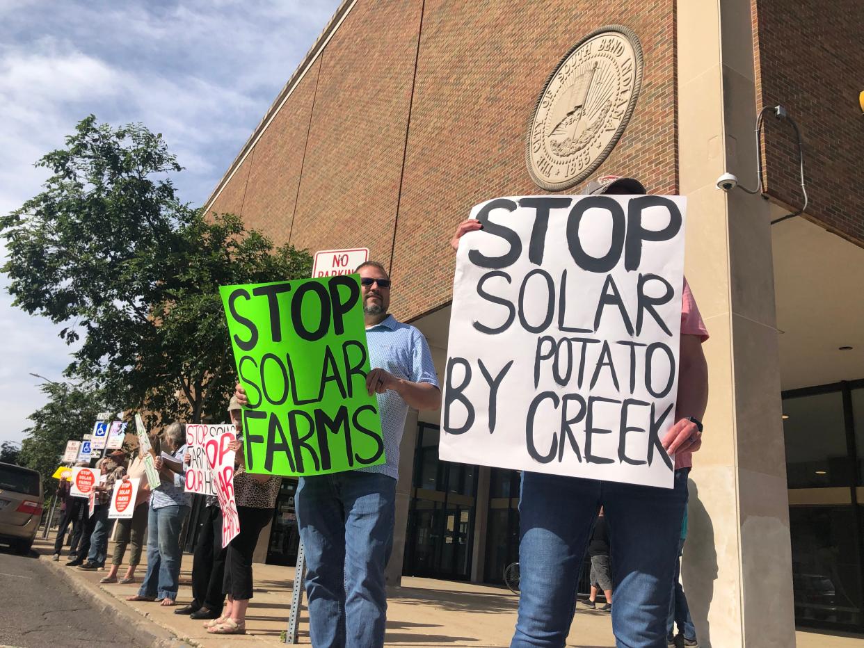 Residents protest against Hexagon Energy's planned solar farms set up outside the County-City building in South Bend, June 11, 2024.