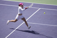 Iga Swiatek, of Poland, returns to Caroline Wozniacki, of Denmark, during a quarterfinal match at the BNP Paribas Open tennis tournament, Thursday, March 14, 2024, in Indian Wells, Calif. (AP Photo/Mark J. Terrill)