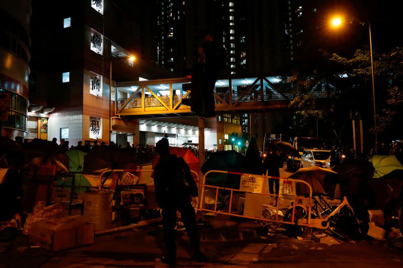 Anti-government protesters set up a barrier to block the road outside of a newly built residential building in Hong Kong that authorities planned to use as a quarantine facility, as public fears about the coronavirus outbreak intensify, in Hong Kong