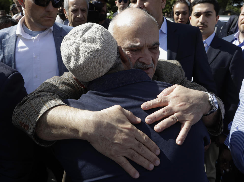 His Royal Highness Prince El Hassan bin Talal Hashemite, of the Kingdom of Jordan, embraces a worshipper outside the Al Noor mosque in Christchurch, New Zealand, Saturday, March 23, 2019. The mosque reopened today following the March 15 mass shooting. (AP Photo/Mark Baker)