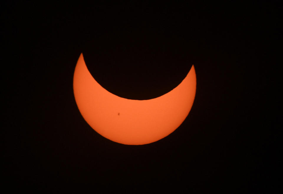 Starting at the Oregon coast and concluding on the east coast of South America, an annular solar eclipse projected a halo of sunlight around the moon's border on Oct. 14, 2023. / Credit: Nick Ut / Getty Images