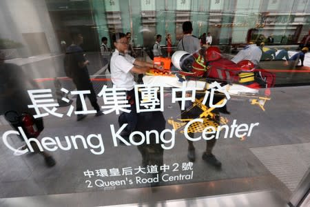 Medical team waits for French urban climber Alain Robert at the Cheung Kong Center building in Hong Kong