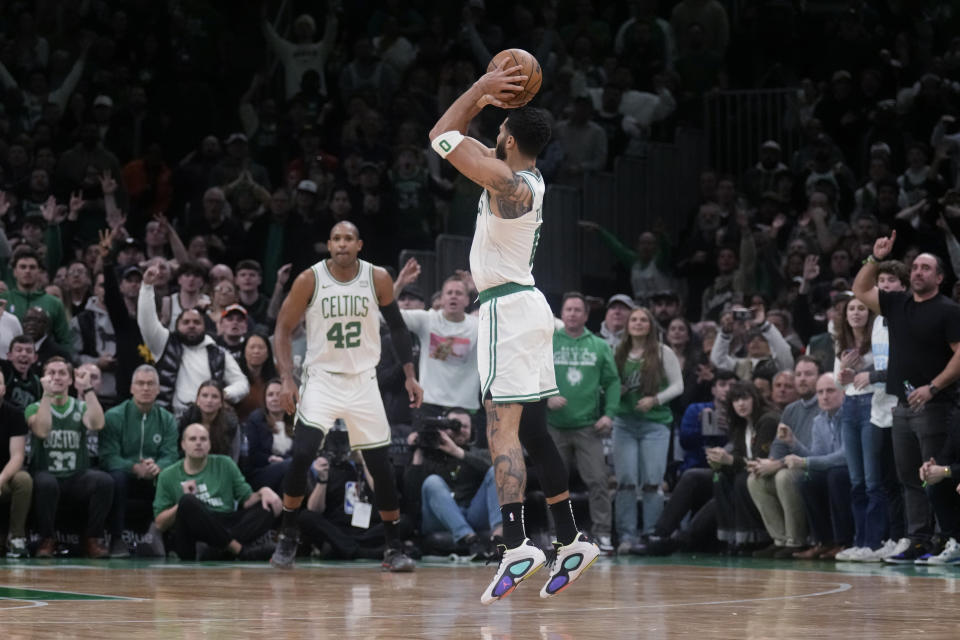 Boston Celtics forward Jayson Tatum (0) shoot a 3-pointer during overtime of the team's NBA basketball game against the Minnesota Timberwolves, Wednesday, Jan. 10, 2024, in Boston. Tatum scored 45 points in the 127-120 Celtics win. (AP Photo/Charles Krupa)