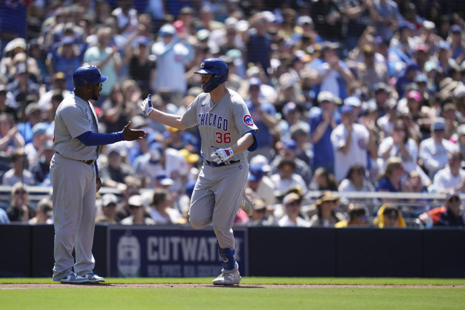 Chicago Cubs' Trey Mancini (36), is greeted by third base coach Willie Harris (33) after hitting a home run during the second inning of a baseball game against the San Diego Padres, Sunday, June 4, 2023, in San Diego. (AP Photo/Gregory Bull)