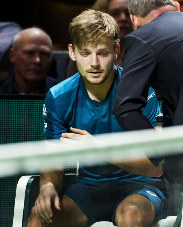 Eye for trouble: David Goffin was forced to quit his semi-final against Grigor Dimitrov after the ball hit him in the eye from a deflection off his own racquet