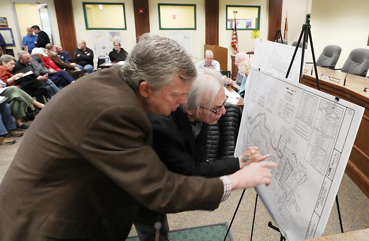 Dave Smith and Joel Owens look over the subdivision plans before the start of a New Franklin Planning & Zoning Commission discussion Wednesday at New Franklin City Hall.