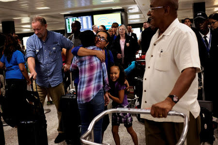 FILE PHOTO: Family members greet international passengers as they arrive at Dulles International Airport in Dulles, Virginia, U.S. September 24, 2017. REUTERS/James Lawler Duggan/File Photo