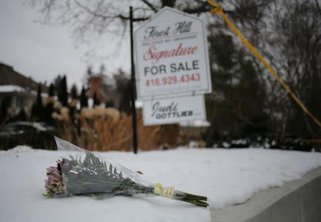 Flowers from mourners are seen outside the home of billionaire founder of Canadian pharmaceutical firm Apotex Inc., Barry Sherman and his wife Honey, who were found dead under circumstances that police described as "suspicious" in Toronto, Ontario, Canada, December 17, 2017. REUTERS/Chris Helgren