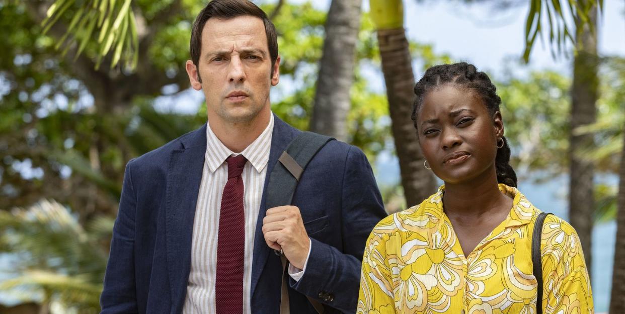 ralf little as neville and shantol jackson as naomi in a scene from death in paradise season 12