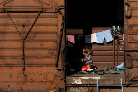 A child cries inside a train wagon used for shelter at a makeshift camp for refugees and migrants at the Greek-Macedonian border near the village of Idomeni, Greece, April 12, 2016. REUTERS/Alexandros Avramidis