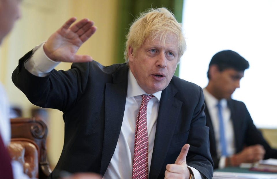 In this photo provided by10 Downing Street, Britain's Prime Minister Boris Johnson chairs his first digital Cabinet meeting inside the Cabinet Room of No 10, since he returned to work after contracting coronavirus and the birth of his new son with his partner Carrie Symonds, in London, Thursday April 30, 2020. (Andrew Parsons/10 Downing Street/via AP)