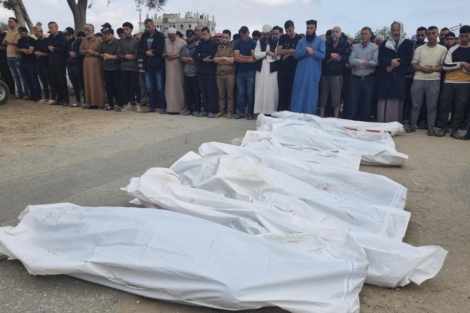 Mourners pray over the bodies of members of the Abu Taha family who were killed in an Israeli airstrike, during their funeral at Al-Salam cemetery, east of Rafah, Gaza Strip. Monday, April 29, 2024. (AP Photo/Mohammad Jahjouh)
