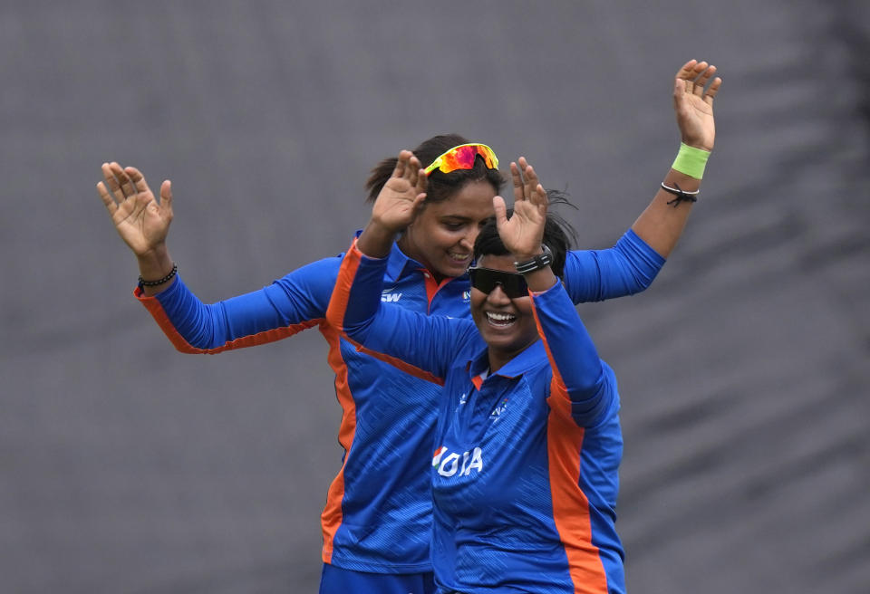 India's Deepti Sharma, front, celebrates with Indian captain Harmanpreet Kaur after dismissing Australia's Rachael Haynes during the women's cricket T20 preliminary round match between India and Australia in Birmingham, England, Friday, July 29, 2022. (AP Photo/Manish Swarup)