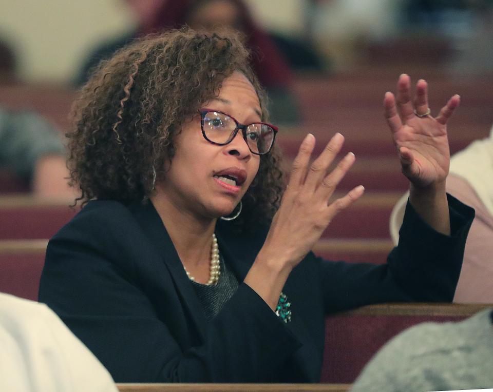 Akron City Councilwoman and mayoral candidate Tara Mosley asks a question Wednesday while seated in the audience during a community conversation on grand juries, use of force, and protesting peacefully at New Hope Baptist Church.