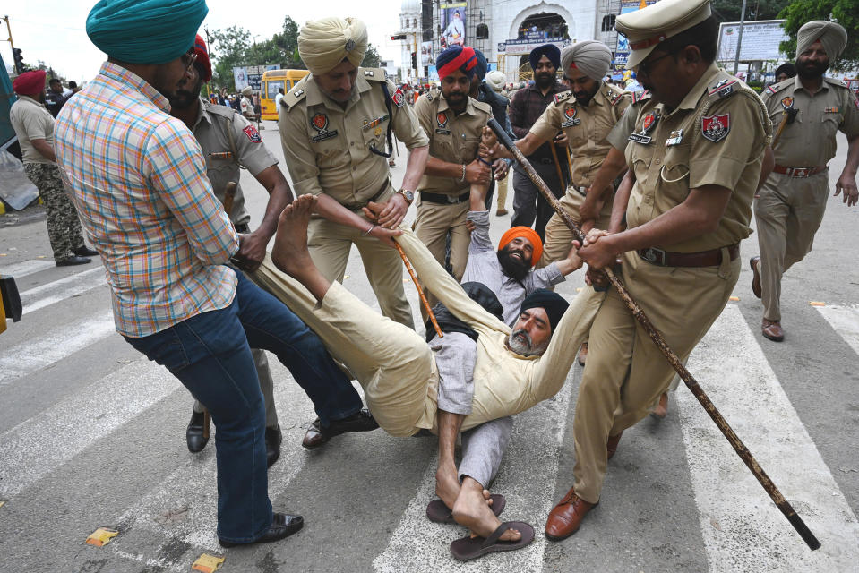 Punjab police forcefully remove supporters protesting the police action against Amritpal Singh in Mohali, India, on March 21.<span class="copyright">Sanjeev Sharma—Hindustan Times/Getty Images</span>