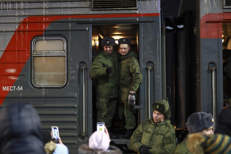 Soldiers who were recently mobilized by Russia for the military operation in Ukraine pose for a photo after a ceremony before boarding a train at a railway station in Tyumen, Russia, Friday, Dec. 2, 2022. Russian President Vladimir Putin's order to mobilize reservists for the conflict prompted large numbers of Russians to leave the country. (AP Photo)