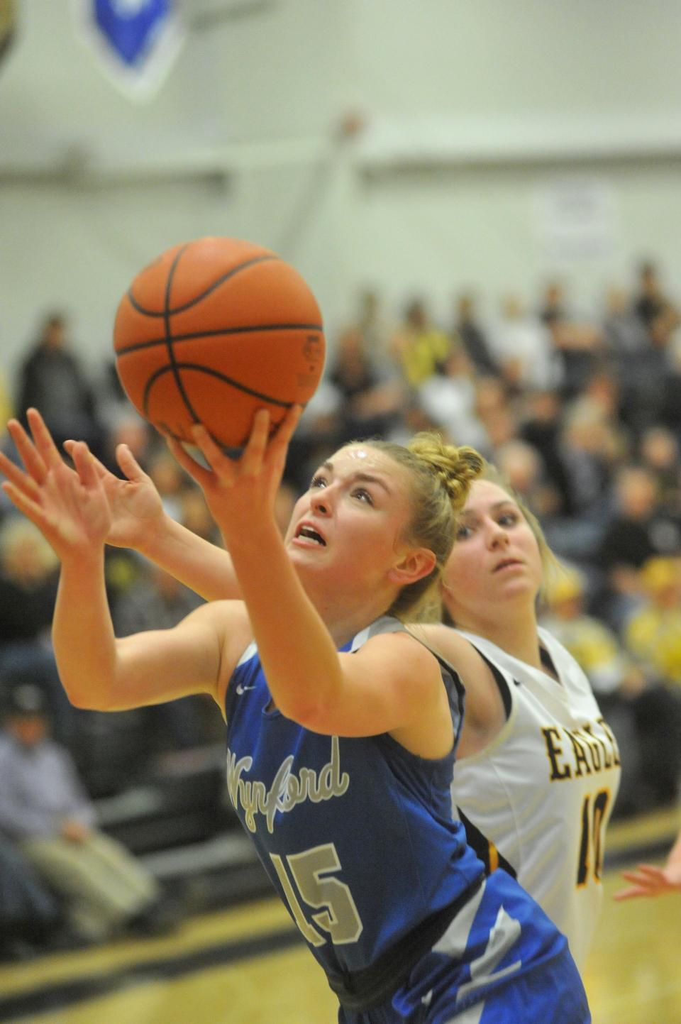 Wynford's Grace Stucky slips past Colonel Crawford's Allison Weithman for a layup.