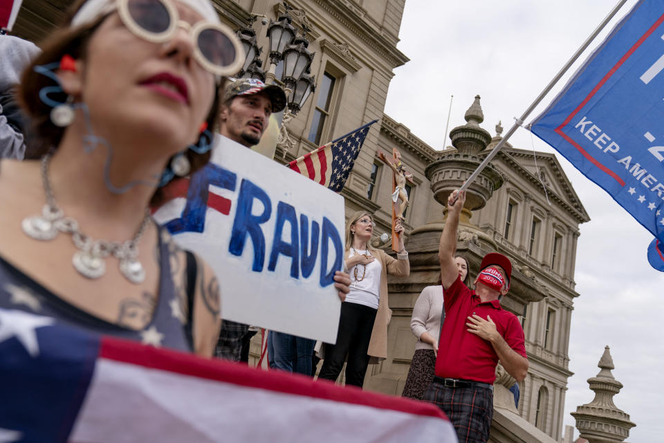 Trump supporters sing the National Anthem while protesting the presidential election results at the State Capitol in Lansing, Mich., Sunday, Nov. 8, 2020. (AP Photo/David Goldman)