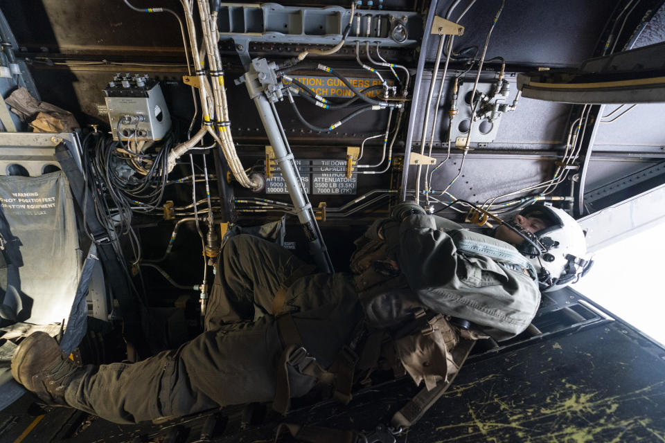 U.S. Marine Cpl. Thalles Souza, rests as a VM-22 Osprey, flies back to base after departing Jeremie Airport, Saturday, Aug. 28, 2021, in Jeremie, Haiti. The VMM-266, "Fighting Griffins," from Marine Corps Air Station New River, from Jacksonville, N.C., are flying in support of Joint Task Force Haiti after a 7.2 magnitude earthquake on Aug. 22, caused heavy damage to the country. (AP Photo/Alex Brandon)