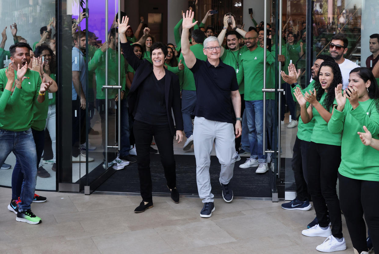 Apple CEO Tim Cook and Deirdre O'Brien, Apple's senior vice president of Retail and People greet people at the inauguration of India's first Apple retail store in Mumbai, India, April 18, 2023. REUTERS/Francis Mascarenhas