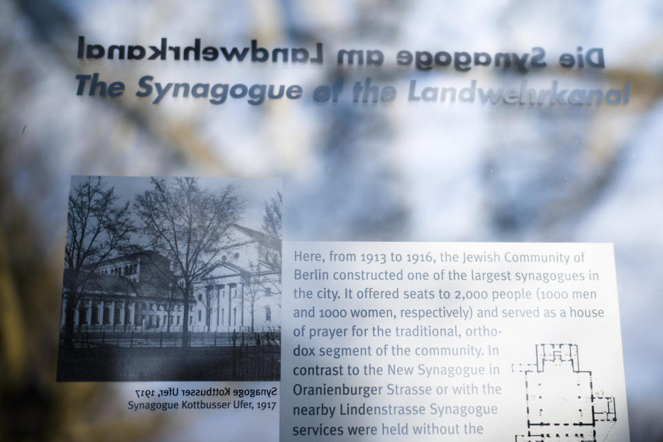 In this Wednesday, March 20, 2019, a remembrance plague displays information and a photo of the former 'Fraenkelufer' synagogue, in Berlin, Wednesday, March 20, 2019. The synagogue was able to receive about 2000 prayers before it was destroyed by the Nazis. In the German capital, efforts are underway to rebuild the synagogue. (AP Photo/Markus Schreiber)