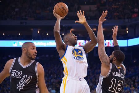 January 25, 2016; Oakland, CA, USA; Golden State Warriors center Festus Ezeli (31) shoots the basketball against San Antonio Spurs forward LaMarcus Aldridge (12) during the first quarter at Oracle Arena. Mandatory Credit: Kyle Terada-USA TODAY Sports