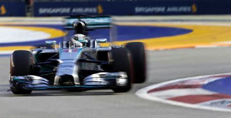 Mercedes Formula One driver Lewis Hamilton of Britain takes a corner during the third practice session of Singapore F1 Grand Prix at the Marina Bay street circuit in Singapore September 20, 2014. REUTERS/Tim Chong