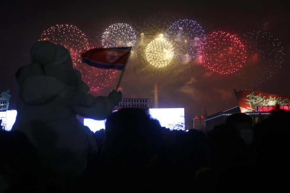 Citizens watch the fireworks celebrating the New Year on Kim Il Sung Square in Pyongyang, North Korea, Saturday, Jan. 1, 2022. (AP Photo/Jon Chol Jin)