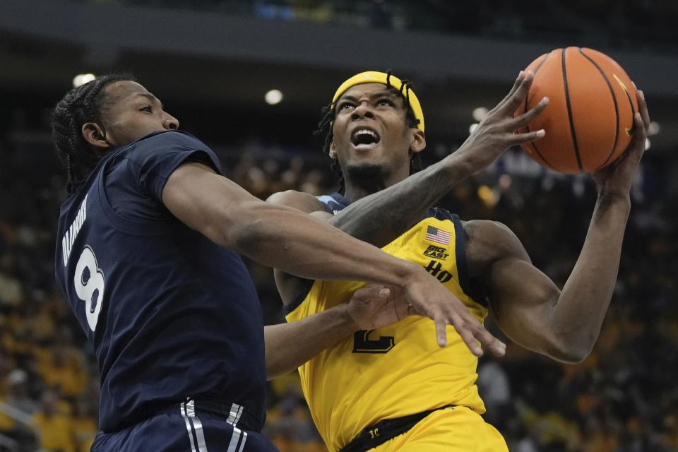 Marquette's Chase Ross is fouled by Xavier's Quincy Olivari during the first half of an NCAA college basketball game Sunday, Feb. 25, 2024, in Milwaukee. (AP Photo/Morry Gash)