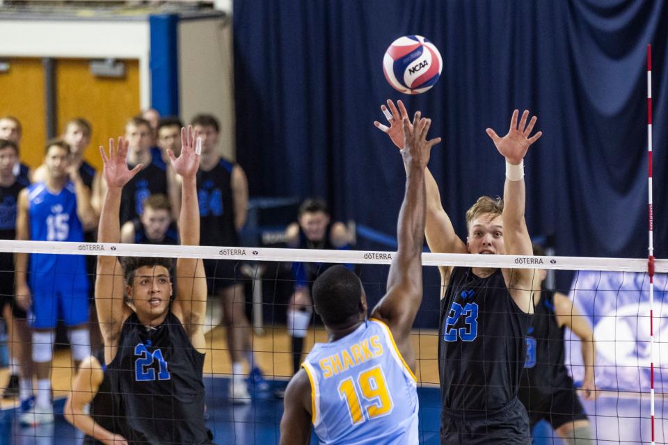 Brigham Young Cougars outside hitter Miks Ramanis (23) jumps for a block against Long Island Sharks opposite hitter Eddy Alexandre (19) during an NCAA men’s volleyball match at the Smith Fieldhouse in Provo on Thursday, Feb. 8, 2023. | Marielle Scott, Deseret News