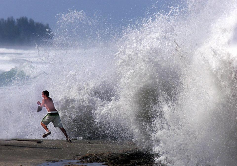 Blowing Rocks Preserve has a history of spectacular waves as they crash into the rocky coastline. In this 1999 file photo, Justin Lane of West Palm Beach makes a dash from the churned surf.