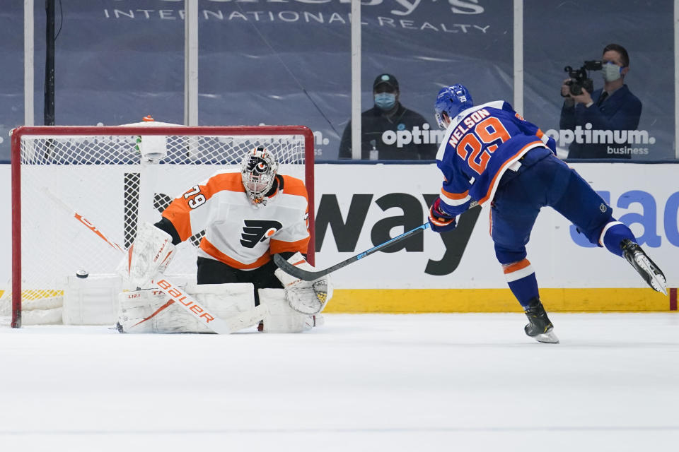 New York Islanders' Brock Nelson (29) shoots the puck past Philadelphia Flyers goaltender Carter Hart (79) for the game winning goal during the shootout period of an NHL hockey game Thursday, April 8, 2021, in Uniondale, N.Y. The Islanders won 3-2. (AP Photo/Frank Franklin II)