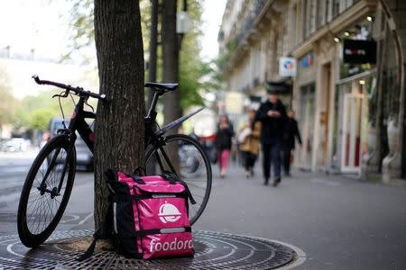 A bicycle and a delivery bag with the logo of Foodora, a Berlin-based online food delivery company, part of the emerging 'gig economy' is seen in Paris, France, April 6, 2017. Picture taken April 6, 2017. REUTERS/Gonzalo Fuentes