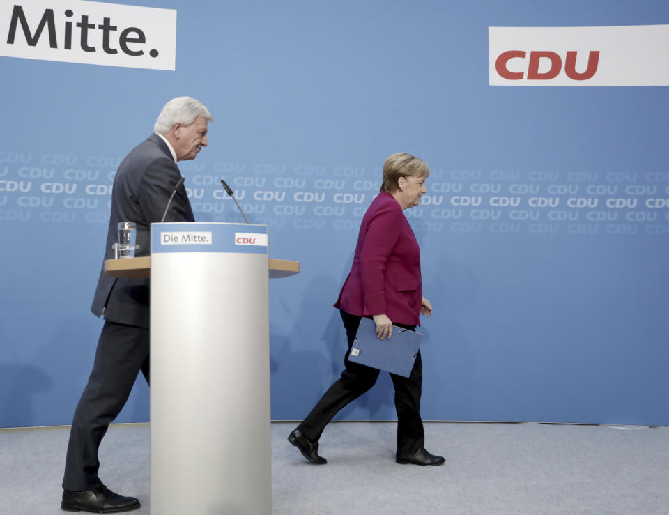 German Christian Democratic Party, CDU, chairwoman and Chancellor Angela Merkel, right, and Hesse Prime Minister and Christian Democratic top candidate of the Hesse state election Volker Bouffier leave after a news conference after a party's leaders meeting at the headquarters the in Berlin, Germany, Monday, Oct. 29, 2018. (Kay Nietfeld/dpa via AP)