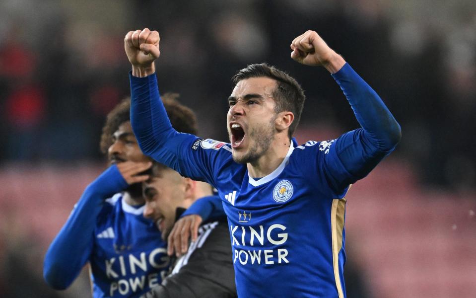 Harry Winks gestures in celebration towards the Leicester fans