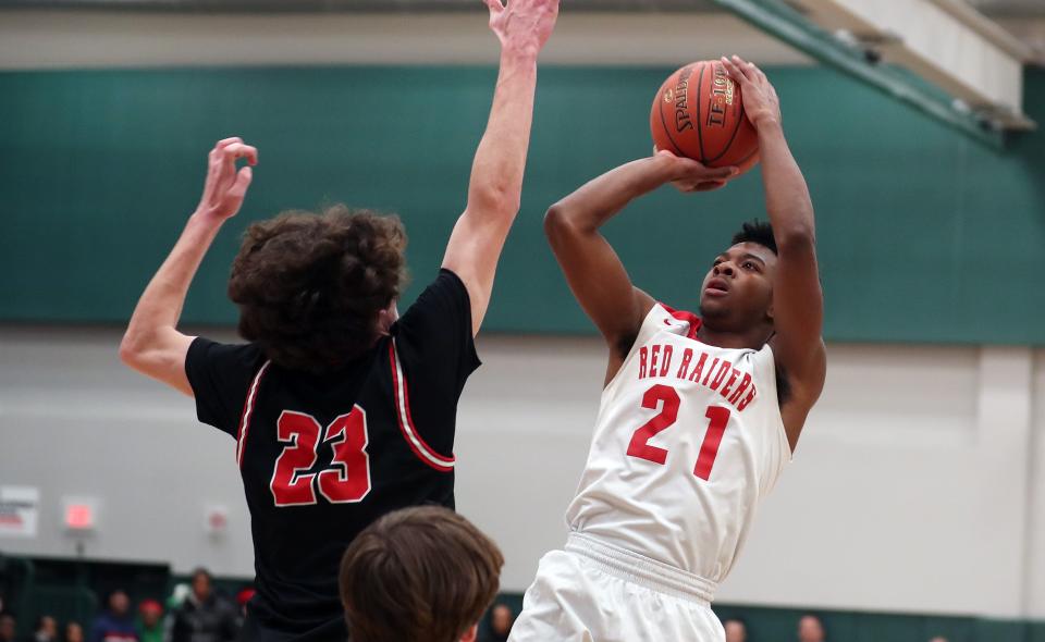 Hamilton's Jaylen Savage (21) puts up a shot in front of Pierson's Charlie Culver (23) during the NYSPHSAA  Class C regional final playoff game at Yorktown High School March 13, 2022. 