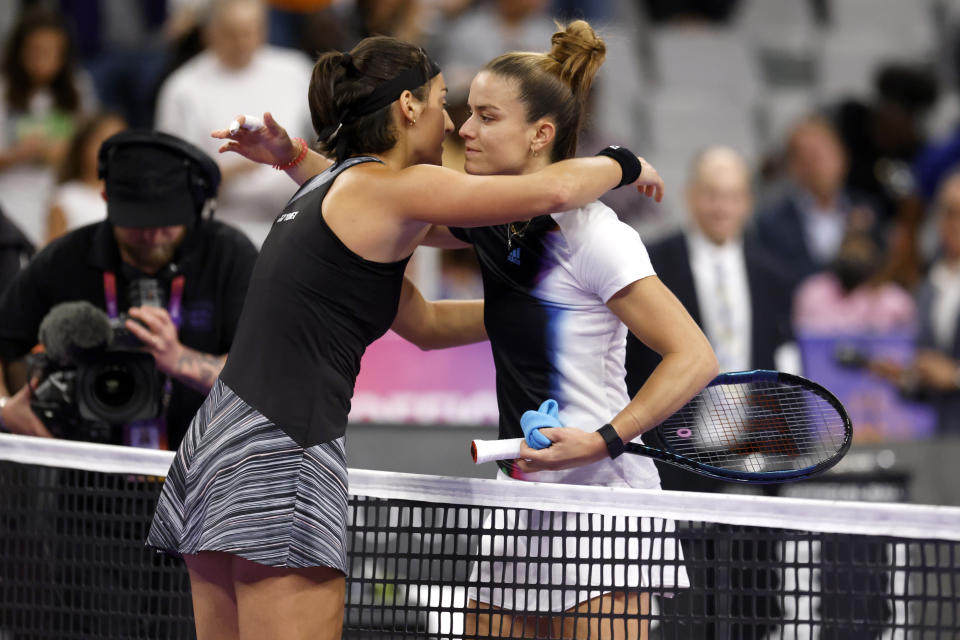 Caroline Garcia, left, of France, and Maria Sakkari, of Greece, embrace at the net following Garcia's win in two sets in the singles semifinals of the WTA Finals tennis tournament in Fort Worth, Texas, Sunday, Nov. 6, 2022. (AP Photo/Ron Jenkins)