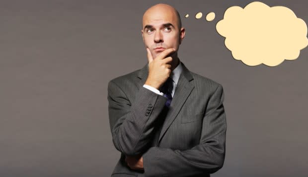 Bald businessman thinking with speech bubble over gray background